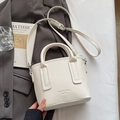 Elegant white lychee leather bucket bag with top handles and adjustable strap - No Pendant / Off White