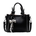 Black bucket bag in lychee pattern leather with silver bow pendant and woven strap - Black Style - With Pendant
