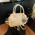 Creamy beige Boston bag with ribbon bows and heart pendant in faux leather finish - With Pendant / Off White
