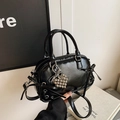 Black glossy Boston handbag with silver heart pendant and decorative side bows - With Pendant / Black