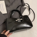 Classic black bucket bag in glossy oil wax leather with metallic twist-lock and handles - No Pendant / Black