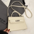 Chic beige lychee leather Kelly style handbag with silver turn-lock and crossbody strap - No Pendant / Off White