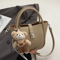Beige litchi leather bucket bag with silver buckle and plush bear pendant detail - With Bear Pendant / Khaki