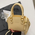 Chic cream yellow bucket bag with lychee texture and gold hardware for crossbody wear - No Pendant / Yellow