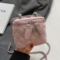 Pink quilted mini box bag with silver flower clasp and chain strap held by model - Small / Pink