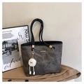 Detailed view of the dark grey vintage tote bag featuring a plush charm and soft faux leather - With Pendant / Black