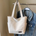 Minimalist beige textured PU leather tote bag with side pockets and branded patch - No Pendant / Off White