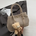Beige woven leather bucket bag with cute plush bear charm on a dark grey suit - Khaki With Overalls Bear