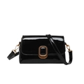 Elegant black patent leather crossbody bag with vintage gold buckle on a white background - Black