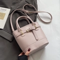 Elegant mauve lychee texture bucket bag with dual handles and golden hardware detail - Purple without Pendant