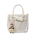 Chic beige lychee textured bucket bag with a cute cartoon charm and adjustable strap - Creamy White (With Doll Charm)