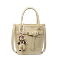 Minimalist beige litchi pattern bucket bag with cute doll charm and shoulder strap - Yellow (With Doll Charm)