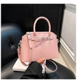 Detail of pink oil wax leather handbag featuring matte finish and decorative belt buckle strap - One Size / Pink