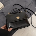 Minimalist black oil-wax leather handbag with golden twist lock and shoulder strap - Black
