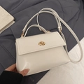 Chic cream white oil wax leather crossbody bag with elegant gold twist lock and handle - White