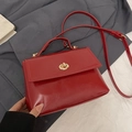 Minimalist red oil wax leather handbag with golden lock and adjustable strap - Red