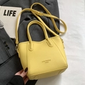 Yellow litchi texture bucket bag with top handles and adjustable strap in a stylish scene - Yellow - No Pendant
