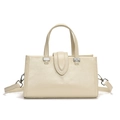 Elegant off-white oil wax leather handbag with silver hardware and adjustable strap - White