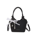 Minimalist black woven bucket bag featuring a white lace bow and pearl charm - Black