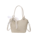 Chic cream white woven bucket bag with pearl lace bow charm and crossbody strap - Off White