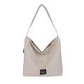Minimalist beige canvas tote bag with black woven label for daily casual shoulder use - Off White