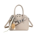 Minimalist apricot seashell crossbody bag with baseball charms and pebbled leather texture - Khaki