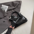 Minimalist black crinkled patent leather triangle bag with silver chain and heart charm - Black