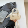 Minimalist beige PU leather mini crossbody bag with unique ball-decorated handles - White