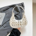White crescent hobo bag featuring silver metallic studs and dual zipper closure - White
