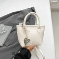 White lychee leather mini tote bag with heart charm and cylindrical handles for women - White