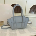 Elegant grey-blue leather handbag with double handles and fine shoulder strap detail - Gray