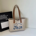 Borsa tote minimalista in tela beige con manici in pelle marrone e ricamo blu - Cachi