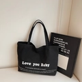 Minimalist black canvas tote bag with white Love You Baby slogan for women's daily commute - Black