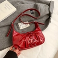 Red glossy patent leather crescent shoulder bag with lace-up detail and silver buckles - Red