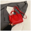Red litchi pattern leather bucket bag with top handle and crossbody strap over grey suit - Red (No Pendant)