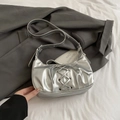 Metallic silver hobo bag featuring decorative cross-lace detailing and adjustable strap - Silver