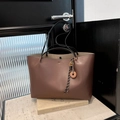 Minimalist coffee brown tote bag with black straps and fringe detail in matte leather finish - With Pendant / Brown