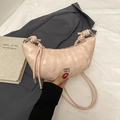 Pale pink crescent dumpling shoulder bag with textured pleats and knot detail - Pink