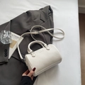 White pebbled leather Boston barrel bag with adjustable strap and dual handles - White Without Pendant