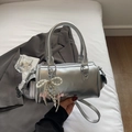 Silver metallic barrel bag with pearl bow charm and long shoulder strap for versatile wear - Silver (With Pendant)
