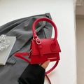 Mini red crossbody bag in lychee texture leather with top handle and silver buckle - Red