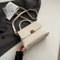 Chic off-white litchi grain square handbag with gold buckle and adjustable strap - Beige