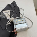 Silver metallic mini backpack with woven trim and a white plush pom-pom charm - Silver with Charm