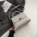 Minimalist grey lychee leather handbag with metal lock and shoulder strap - Gray