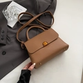 Elegant brown litchi pattern handbag with gold hardware and adjustable strap - Brown