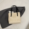 Minimalist beige woven straw tote bag with long black leather handles for women - Black Without Charm