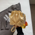 Pale yellow leather bucket bag with drawstring closure and colorful elephant charm - With Charm / Yellow