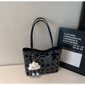 Detail view of black tote bag with geometric maze pattern and plush cloud charm - Black With Pendant