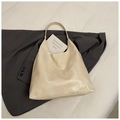 Minimalist cream white leather tote bag shown in a flat lay on a grey blazer suit - Off White