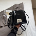 Classic black shell-shaped PU leather crossbody bag with dual straps and logo patch - Black